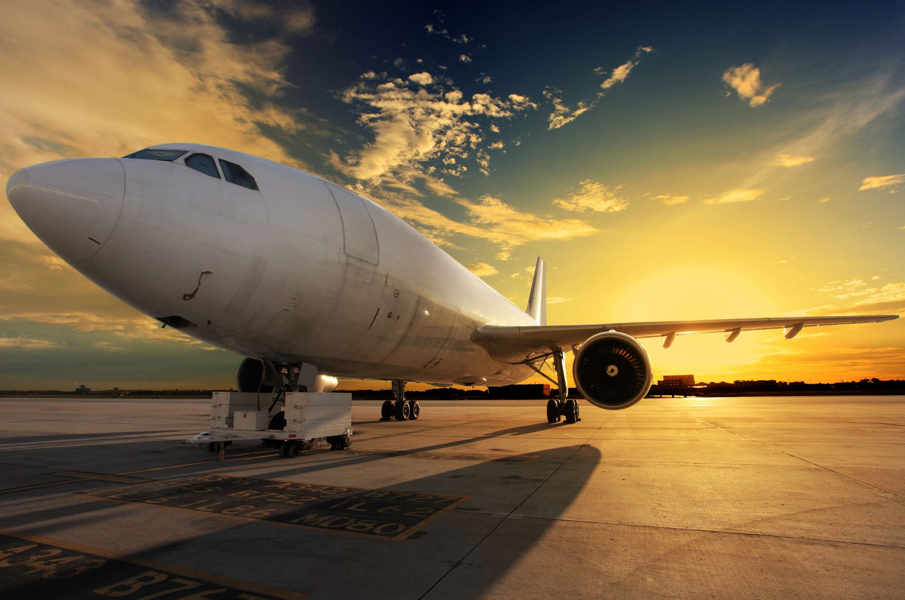 An aircraft on the runway at sunset