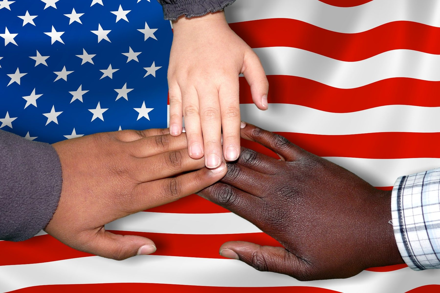 Hands over a world map representing international migration